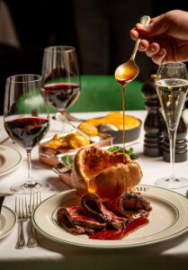 A digital asset with an illustration of a fillet and wine bottle